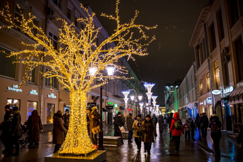 Glowing Yellow Christmas Lights And Trees On The Street