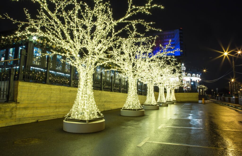 Glowing Yellow Christmas Lights And Trees On The Street